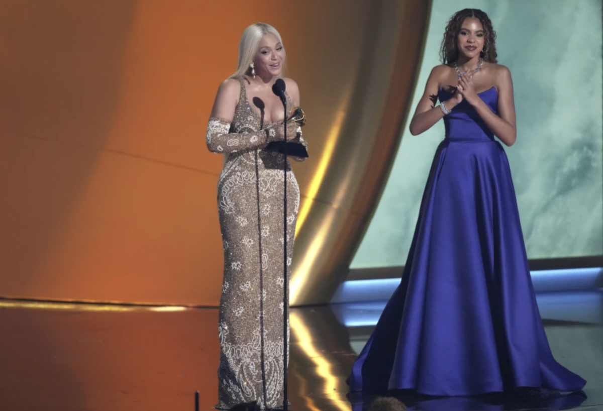 Beyonce accepts the award for album of the year for “COWBOY CARTER during the 67th annual Grammy Awards on Sunday, Feb. 2, 2025, in Los Angeles. Blue Ivy Carter looks on from right.